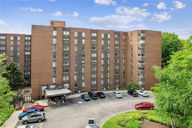 view of apartment building / complex featuring uncovered parking