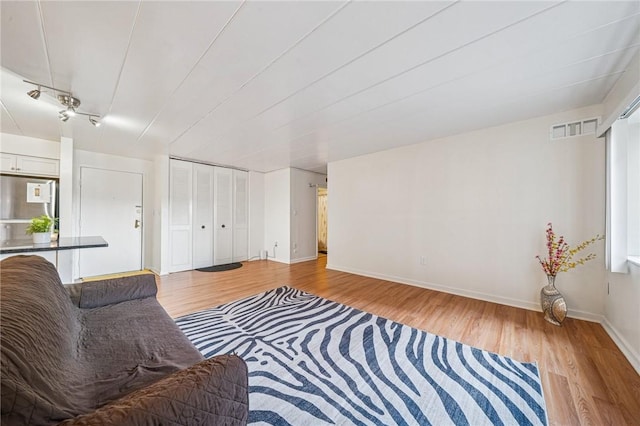 living room featuring light wood finished floors and baseboards