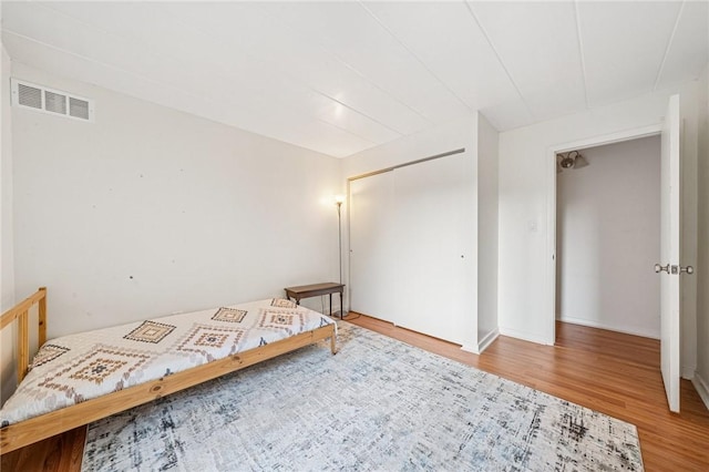 bedroom featuring wood finished floors and a closet