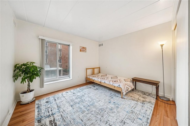 bedroom featuring wood finished floors and baseboards