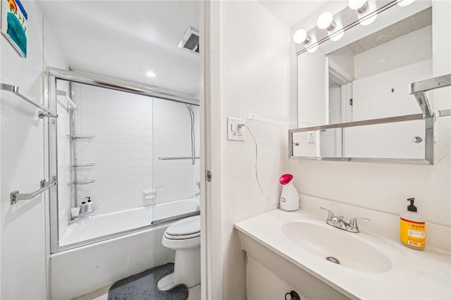 full bath featuring toilet, enclosed tub / shower combo, vanity, and recessed lighting