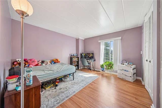 bedroom with wood finished floors and a desk