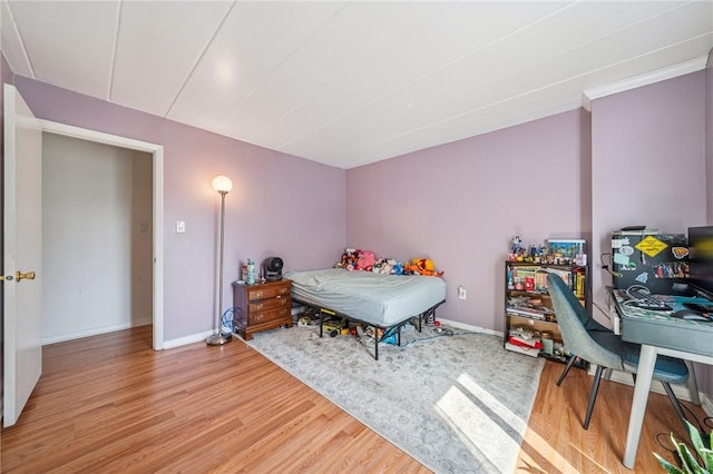 bedroom with wood finished floors and baseboards