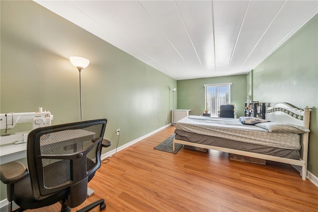 bedroom with wood finished floors and baseboards