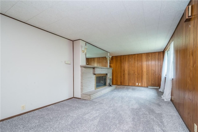 6109 Roy St, Union Twp, PA 15332 - unfurnished living room with carpet, wood walls, a brick fireplace, and baseboards