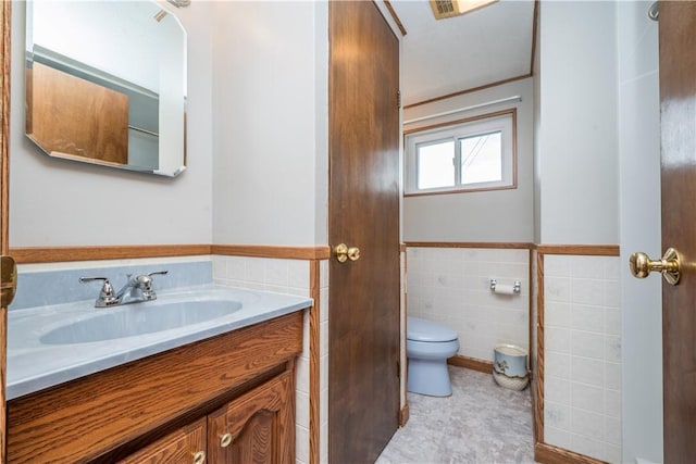 6109 Roy St, Union Twp, PA 15332 - bathroom featuring tile walls, toilet, vanity, and a wainscoted wall