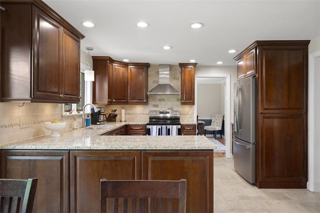 1805 Taper Dr, Upper St Clair, PA 15241 - kitchen with stainless steel appliances, wall chimney exhaust hood, a sink, a peninsula, and backsplash