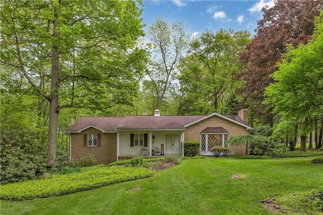 ranch-style house with a front yard, a porch, and a chimney