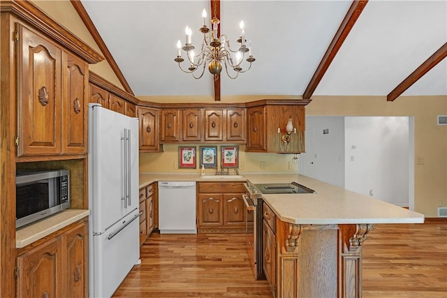 kitchen with appliances with stainless steel finishes, a peninsula, light wood-style floors, a chandelier, and brown cabinetry