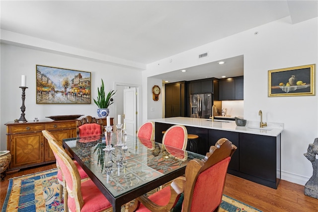 dining room with light wood finished floors and baseboards