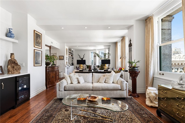 living room with beverage cooler, wood finished floors, recessed lighting, and baseboards