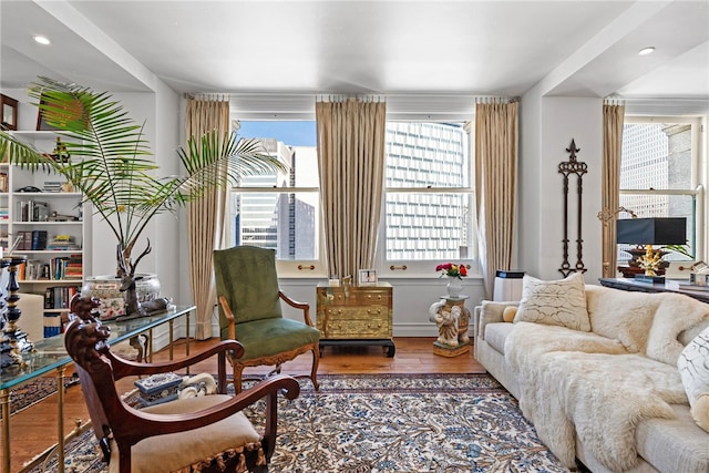 living area featuring wood finished floors, healthy amount of natural light, and recessed lighting