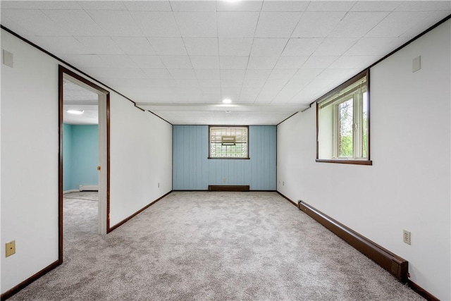basement with carpet, baseboards, and a baseboard radiator
