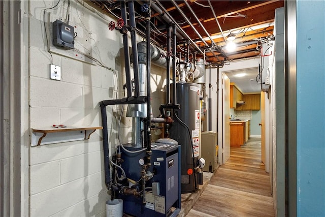 utility room with gas water heater and a heating unit