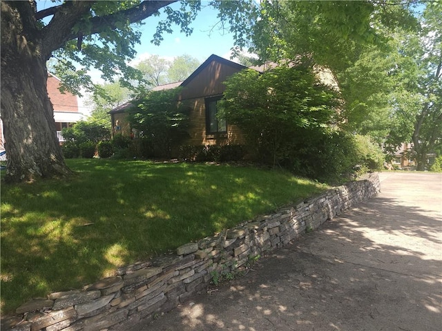 view of side of home with a lawn