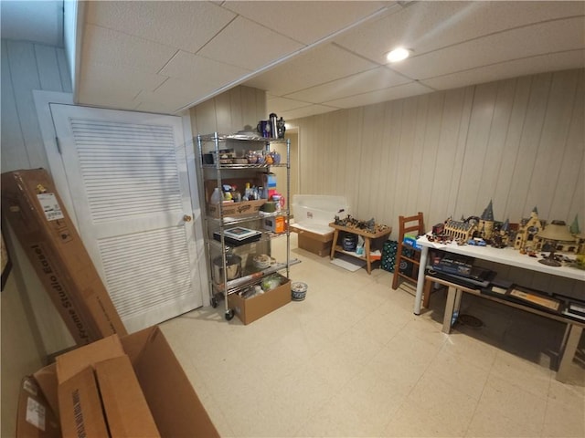 finished below grade area with light floors and wood walls