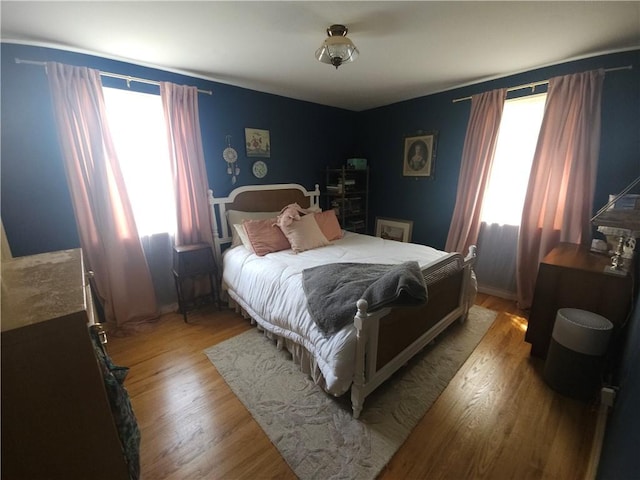 bedroom featuring light wood-type flooring and baseboards