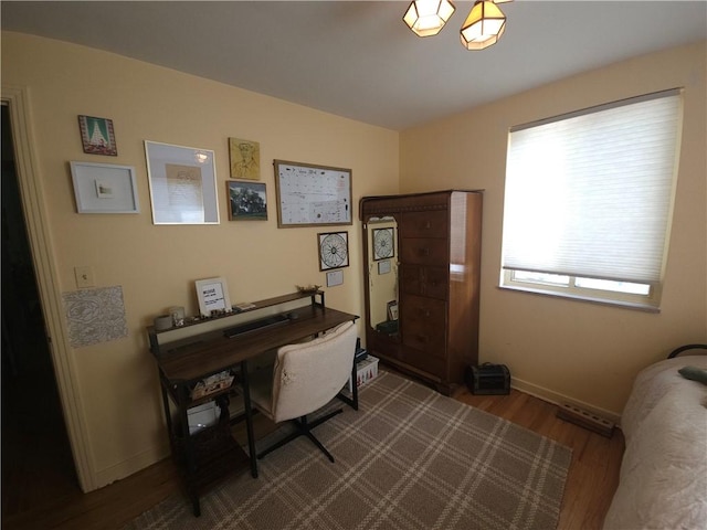 home office with dark wood-style floors and baseboards