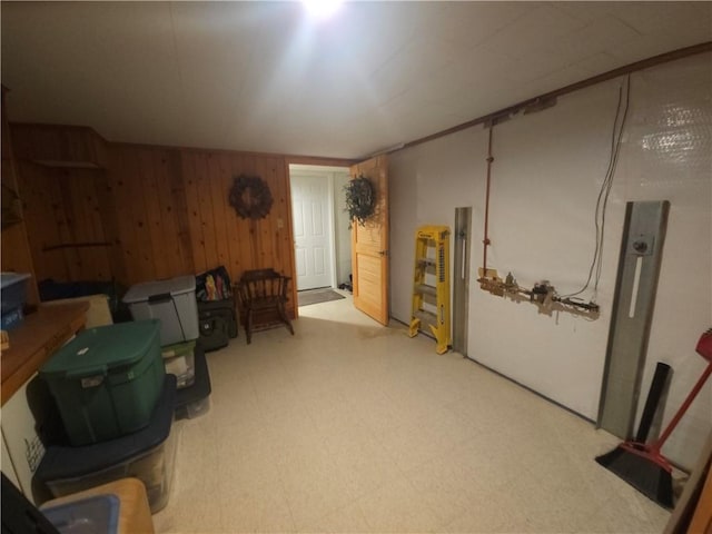 miscellaneous room featuring wooden walls and tile patterned floors