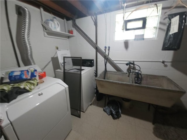 washroom featuring separate washer and dryer and concrete block wall