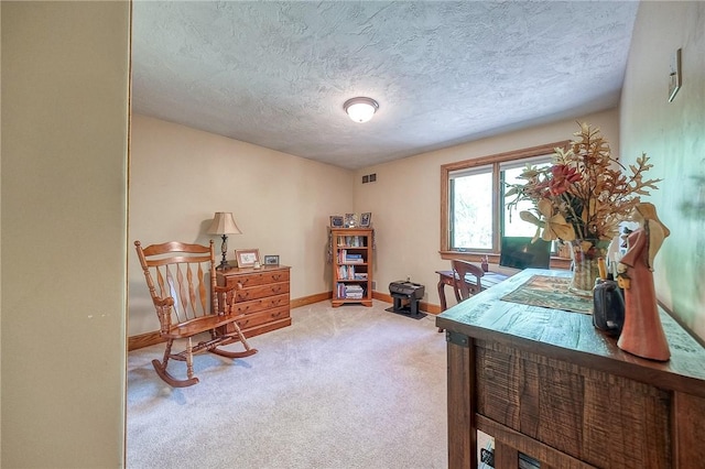 office area featuring carpet floors, a textured ceiling, and baseboards