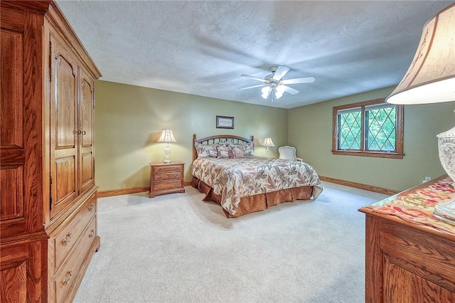 bedroom featuring baseboards, light carpet, ceiling fan, and a textured ceiling