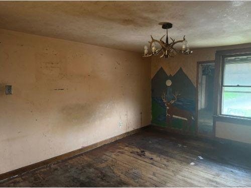 543 Highland Ave, Kittanning Boro, PA 16201 - empty room with a chandelier, wood finished floors, and baseboards