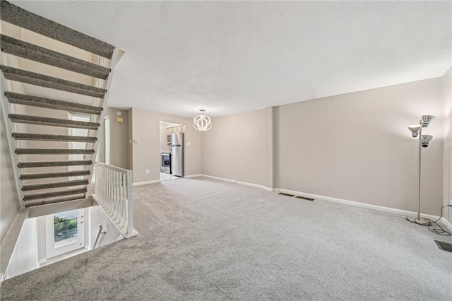 610 Arkwood Dr, Bethel Park, PA 15102 - carpeted empty room featuring baseboards and a chandelier