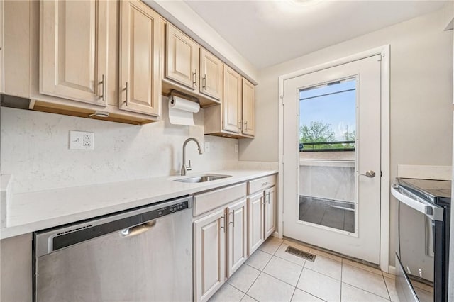 610 Arkwood Dr, Bethel Park, PA 15102 - kitchen featuring stainless steel appliances, a sink, light countertops, light tile patterned flooring, and light brown cabinets