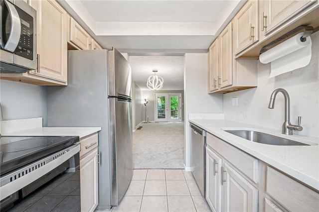610 Arkwood Dr, Bethel Park, PA 15102 - kitchen with stainless steel appliances, a sink, light colored carpet, and light countertops
