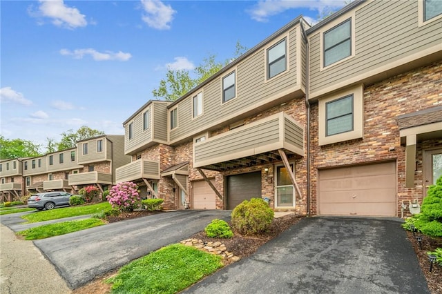 610 Arkwood Dr, Bethel Park, PA 15102 - view of front facade with driveway, brick siding, a garage, and a residential view