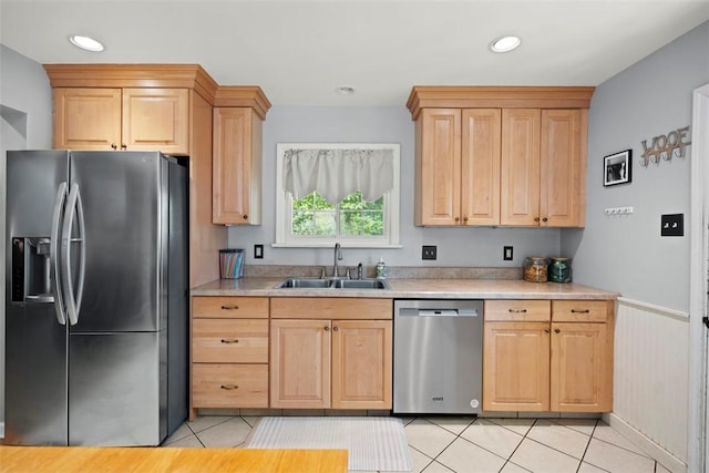 701 Thorn St, Sewickley, PA 15143 - kitchen with stainless steel appliances, a sink, light tile patterned floors, light brown cabinetry, and a wainscoted wall