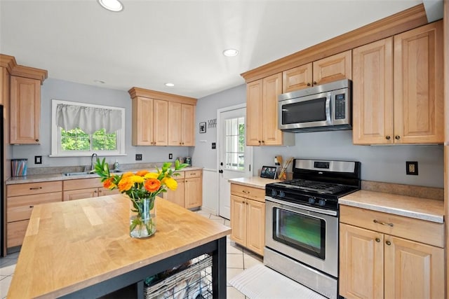 701 Thorn St, Sewickley, PA 15143 - kitchen with stainless steel appliances, light brown cabinetry, a sink, light tile patterned floors, and recessed lighting