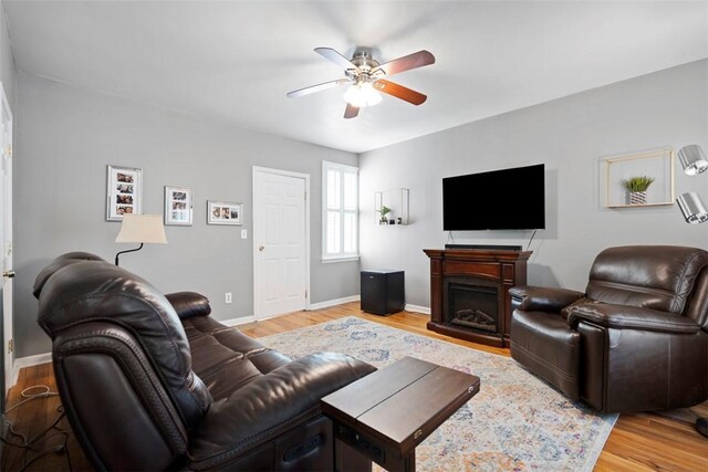 701 Thorn St, Sewickley, PA 15143 - living room featuring a ceiling fan, light wood finished floors, a fireplace, and baseboards