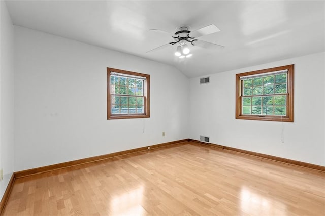 unfurnished room with light wood-style floors, plenty of natural light, ceiling fan, lofted ceiling, and baseboards
