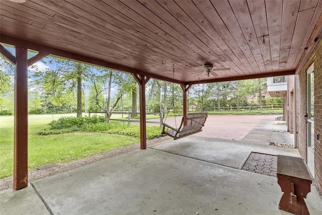 view of patio / terrace featuring ceiling fan and view of scattered trees