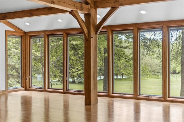 doorway with healthy amount of natural light, recessed lighting, and wood finished floors
