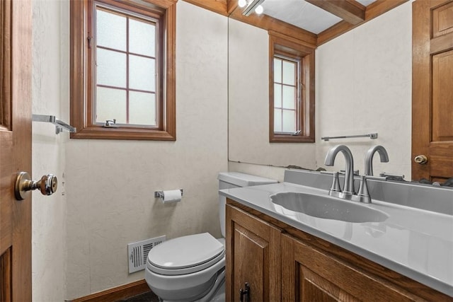 bathroom featuring toilet and vanity