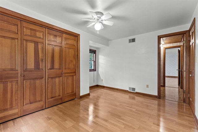 unfurnished bedroom with light wood-style floors, baseboards, and a ceiling fan
