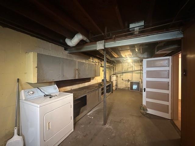 unfinished basement featuring washer / dryer