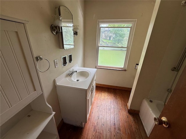 2895 Hemlock St, Bethel Park, PA 15102 - full bathroom featuring wood finished floors, vanity, a bath, baseboards, and a shower