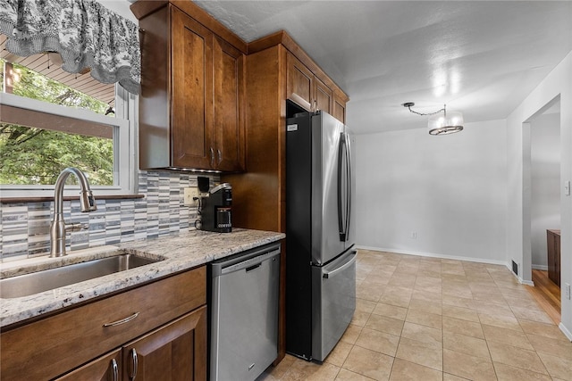187 Anderson Rd, North Huntingdon, PA 15642 - kitchen with appliances with stainless steel finishes, a sink, tasteful backsplash, light stone counters, and baseboards