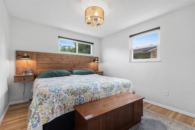 187 Anderson Rd, North Huntingdon, PA 15642 - bedroom with baseboards, wood finished floors, and a chandelier