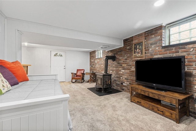 187 Anderson Rd, North Huntingdon, PA 15642 - carpeted living room with a wood stove and brick wall