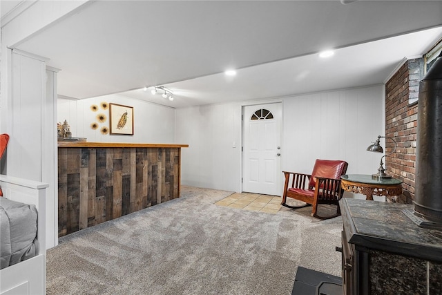 187 Anderson Rd, North Huntingdon, PA 15642 - living area featuring a wood stove, carpet flooring, and a bar