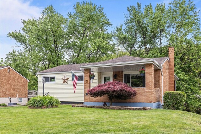 187 Anderson Rd, North Huntingdon, PA 15642 - bungalow-style home featuring a chimney and a front lawn