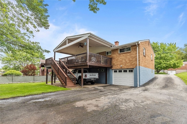 187 Anderson Rd, North Huntingdon, PA 15642 - view of front of home with a ceiling fan, a garage, a deck, stairway, and driveway