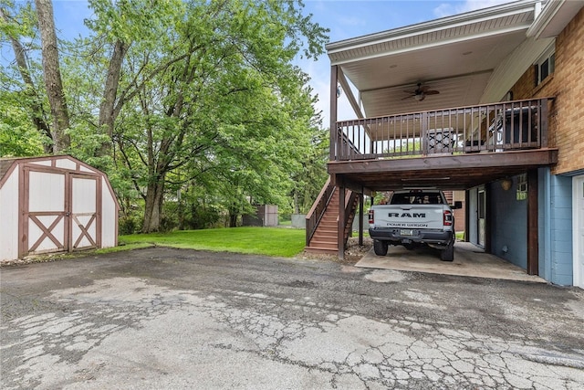 187 Anderson Rd, North Huntingdon, PA 15642 - view of parking / parking lot with a storage unit, a ceiling fan, asphalt driveway, stairway, and a carport