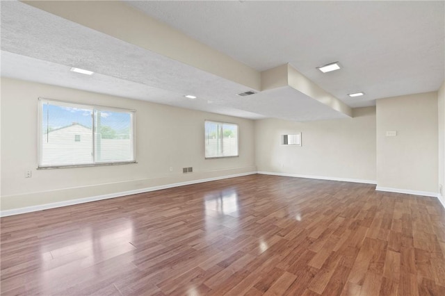 spare room with wood finished floors and baseboards