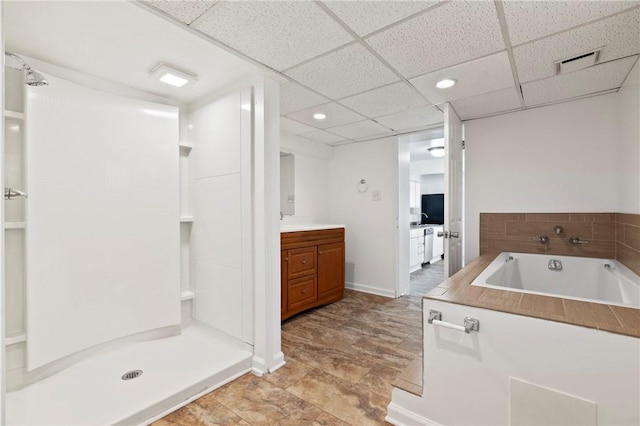 bathroom with a bath, vanity, a drop ceiling, a shower stall, and recessed lighting